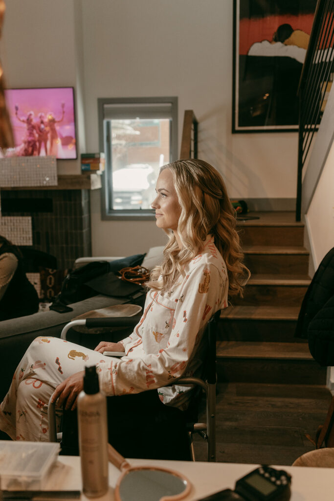 Bride gets hair styled in cozy pajamas before her Jackson Hole Cloudveil wedding