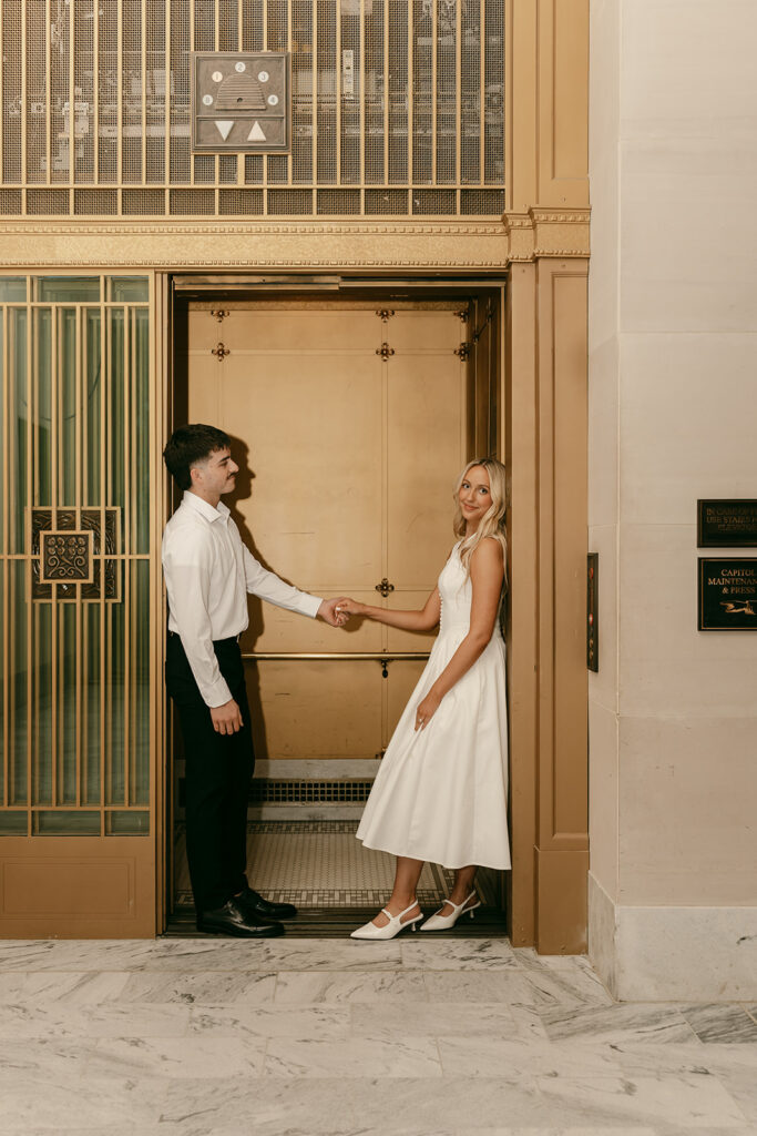 Salt Lake engagement photography moment in front of historic gold elevator