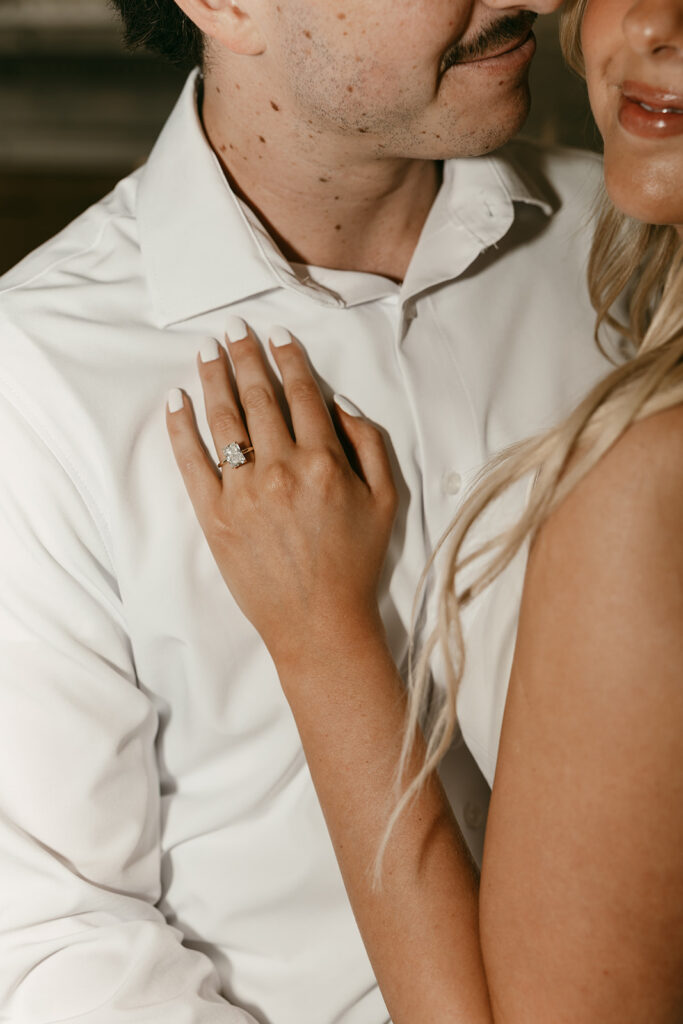 Salt Lake engagement photography close-up of ring hand resting on groom’s chest
