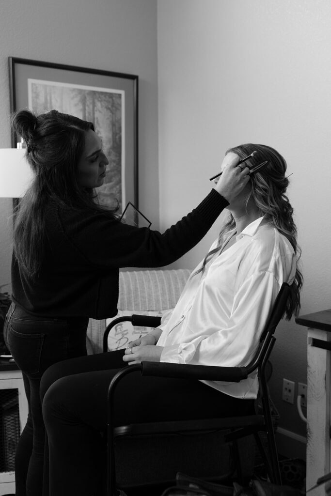 Makeup artist applies final touches as the bride gets ready for Sonoma County destination wedding