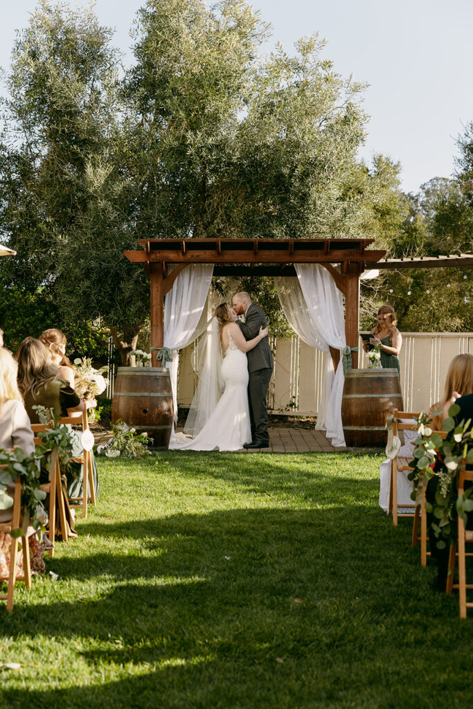 Newlyweds share their first kiss during the ceremony at this Sonoma County destination wedding.