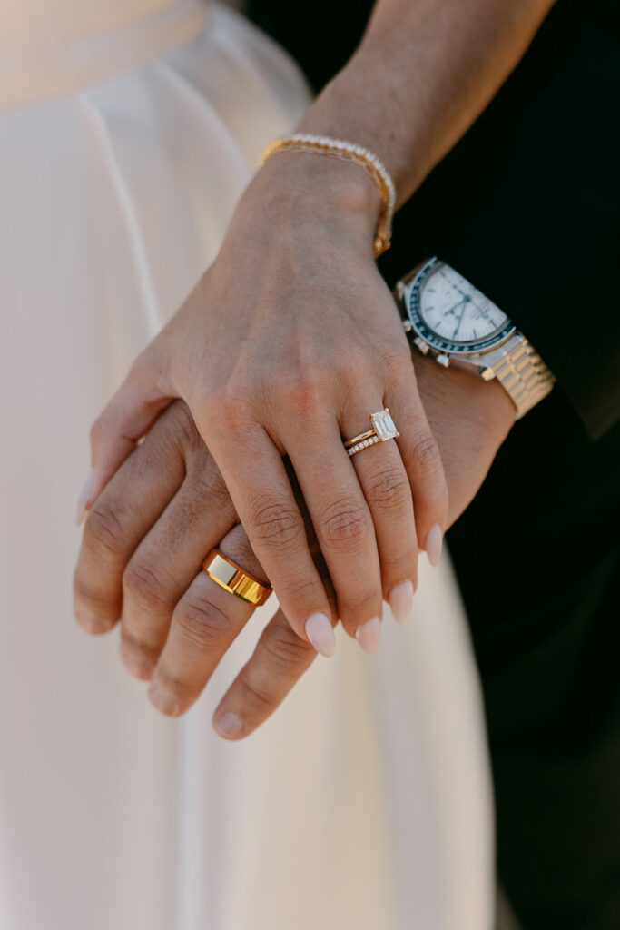 Close-up of hands with rings during Wyoming Wedding Tree elopement.