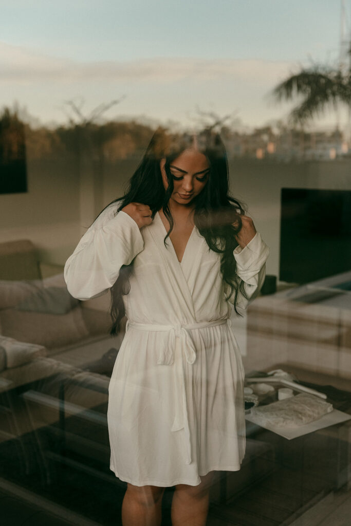 Bride in robe getting ready inside Spanish villa on the morning of the elopement
