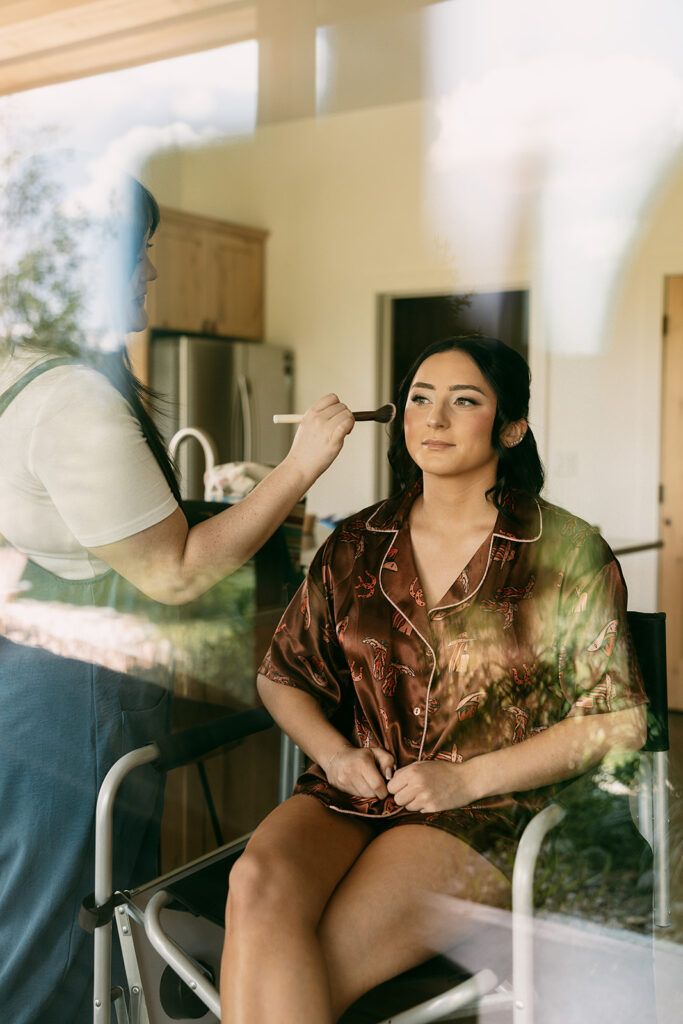 Bride getting her makeup done before Jackson Hole elopement