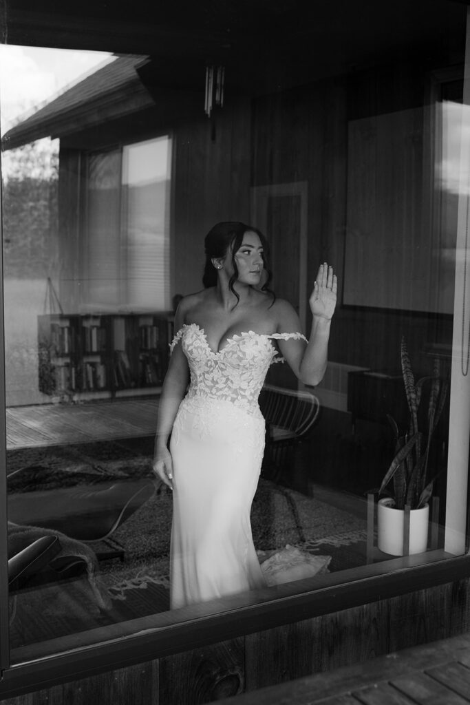 Glamorous bridal portrait through a large window