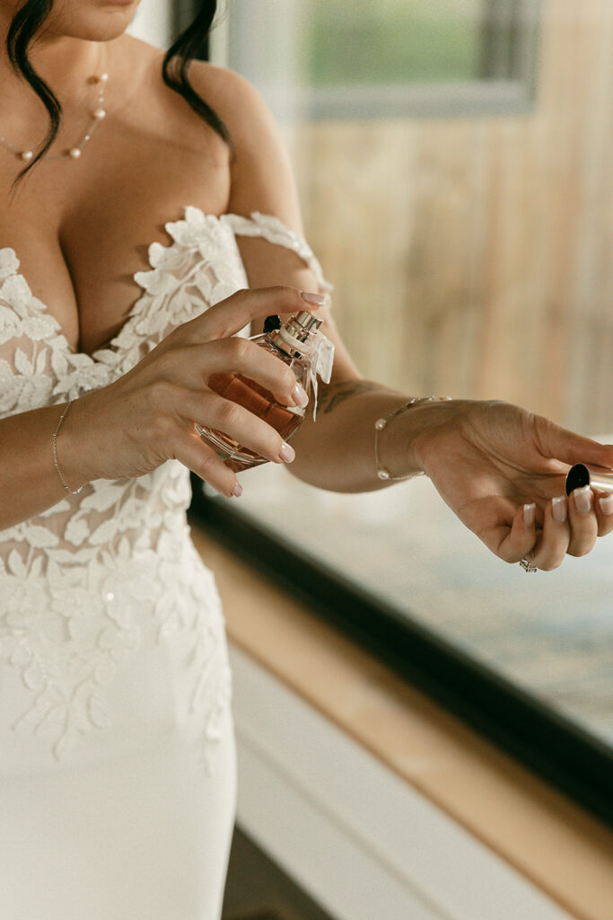 Bride puts on perfume before her Jackson Hole elopement