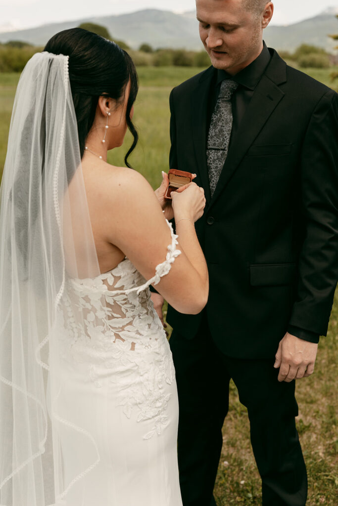 Couple exchanges rings during Schwabacher Landing elopement