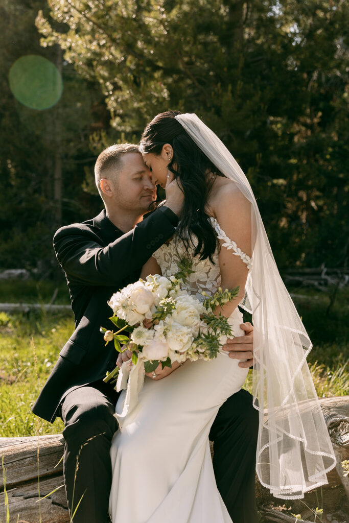 Bride sits on groom's lap for an intimate elopement photo