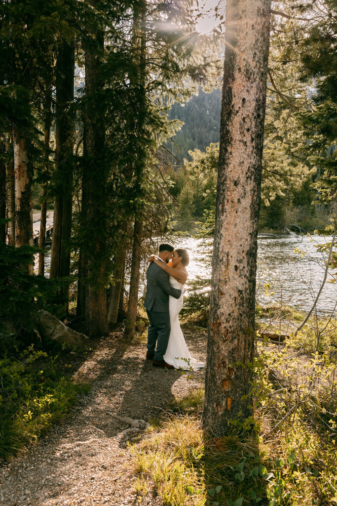 Bride and groom share an intimate moment during their summer elopement in the Tetons