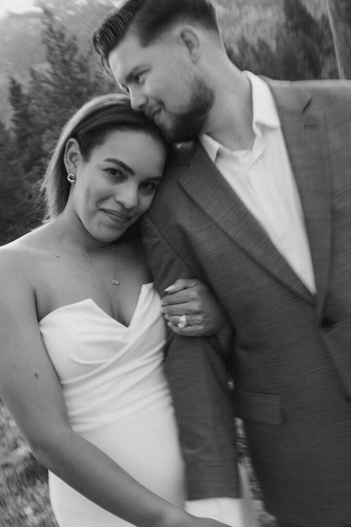 Bride leans her head on groom's shoulder during summer elopement in the Tetons
