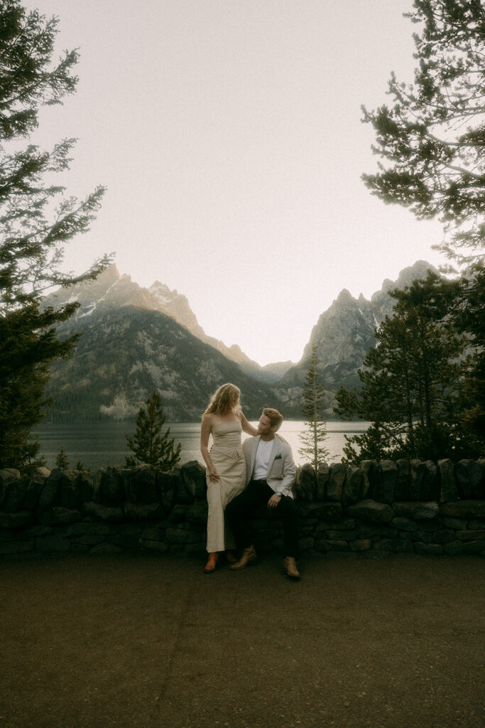 Man looks at his fiancé during sunset adventure engagement photoshoot