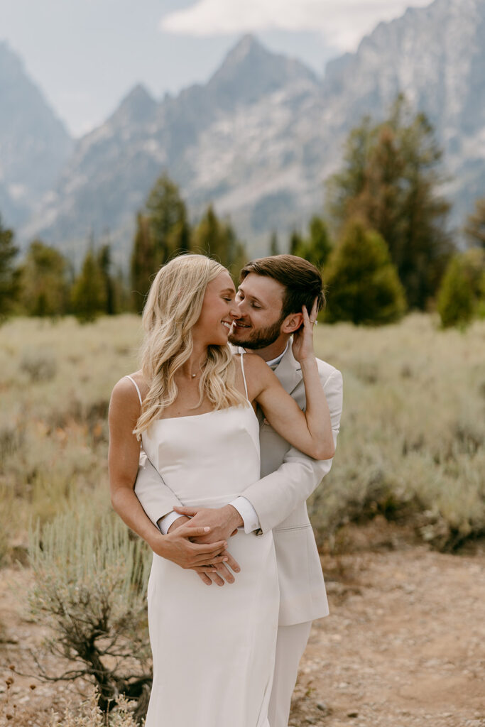 Bride and groom share a sweet moment during Jackson Lake Lodge wedding photos