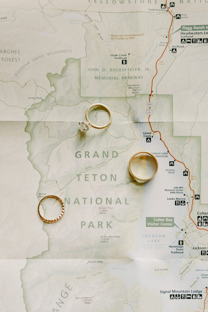 Three wedding rings displayed on top of Grand Teton National Park map