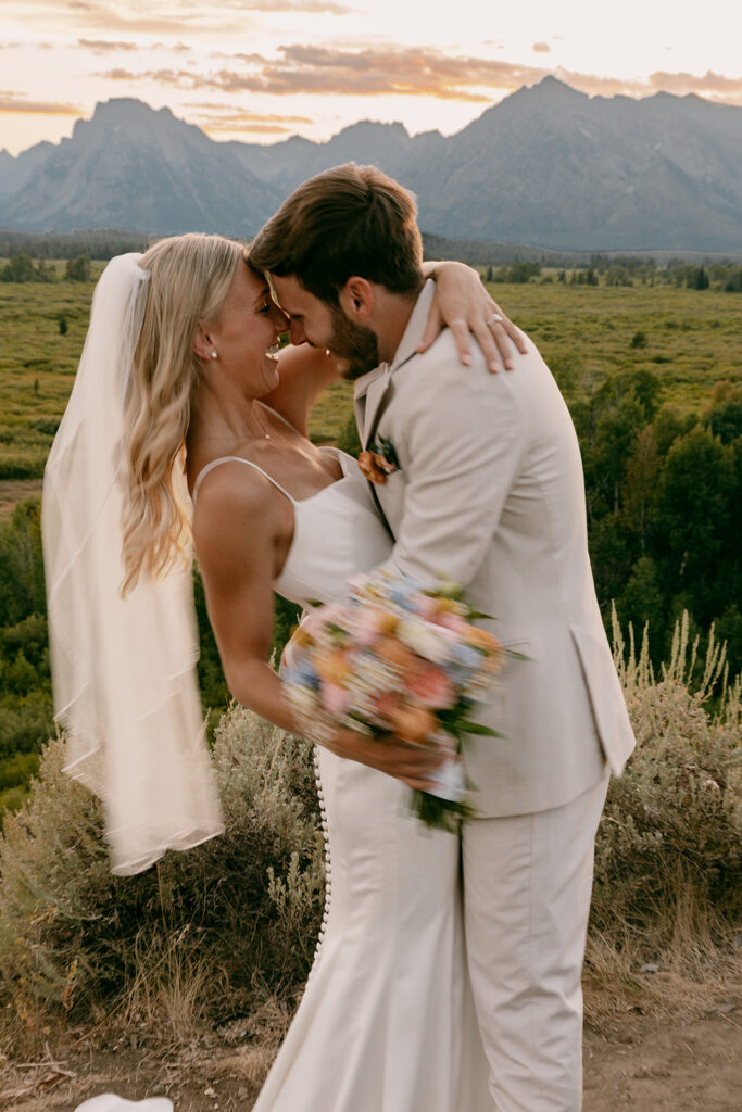 Blurred bride and groom laughing together during Jackson Lake Lodge wedding portrait session