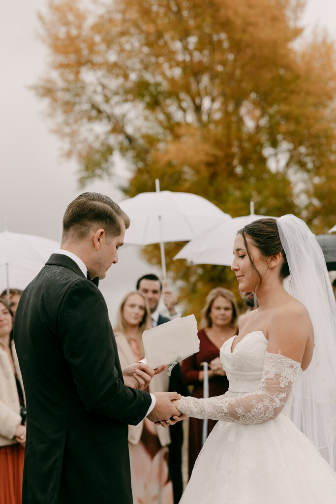 Bride and groom exchange vows during Grand Teton wedding day ceremony.